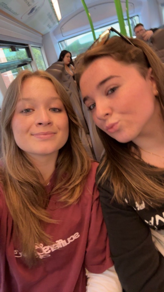 Ruby and Lucy smiling on the train
